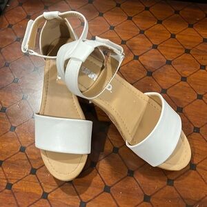 Synthetic white sandle w/ cork wedge heel and adjustable Velcro ankle strap
